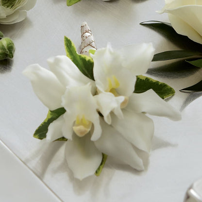 White Mini Cymbidium Boutonniere –  Temptation Flower Shop, Wichita KS